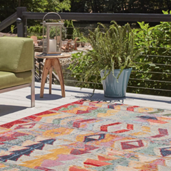 A colourful rug on a deck