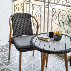A dark chair and a table on a balcony