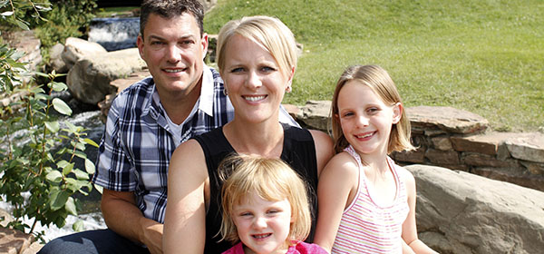 Suzanne Maynard, her husband Gord Clark and daughters Sydney, 3, and Evelynn, 6, enjoying spending warm summer days and nights at their private community lake. Photo by Paula Trotter/Fore CREB®Now.