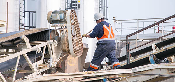 Conveyers at the City of Calgary's asphalt plant, where the mix travels up into the machines. Workers will then push the mix through to make sure it does not jam. Photo by Michelle Hofer/For CREB®Now