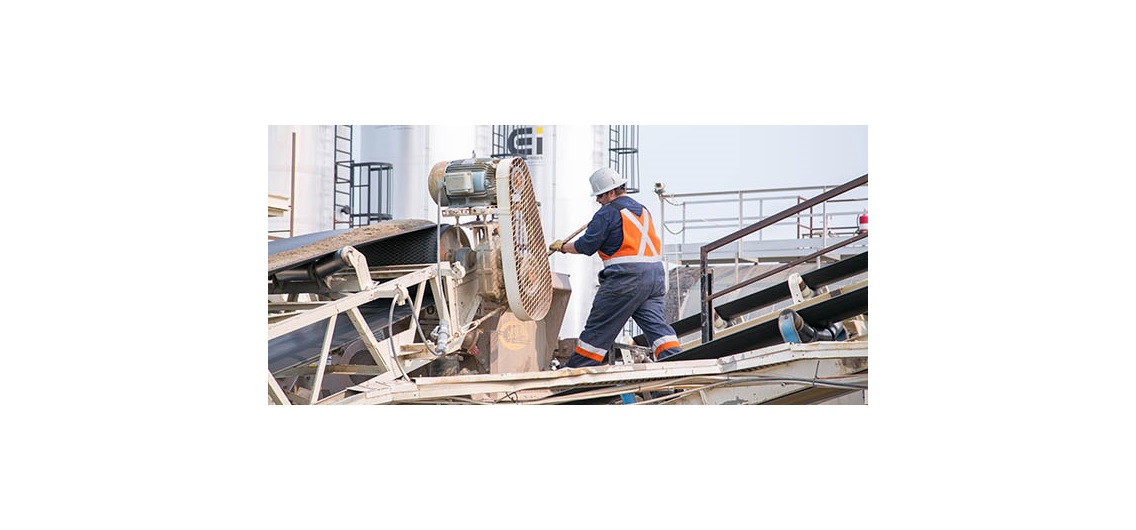 Conveyers at the City of Calgary's asphalt plant, where the mix travels up into the machines. Workers will then push the mix through to make sure it does not jam. Photo by Michelle Hofer/For CREB®Now
