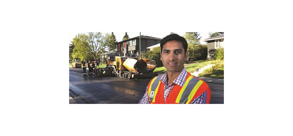 Venkat Lakkavalli, pavement engineer with the City of Calgary, beside a paving crew in the southwest community of Killarney. Photo by Wil Andruschak/for CREB®Now