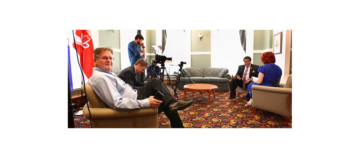 In-Houze Productions co-founder Doug Hayden sits in the foreground while his team interviews Calgary Mayor Naheed Nenshi for an upcoming Shaw TV series titled Calgary Homes & Lifestyles.