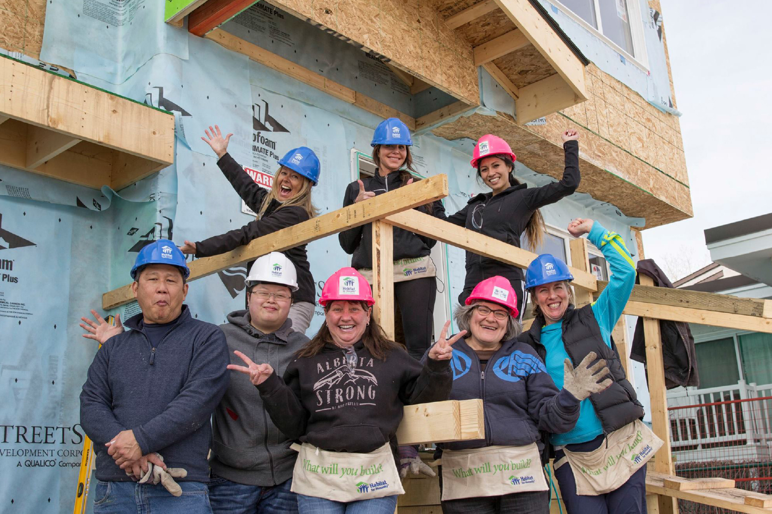 A group of Calgary and area REALTORS® celebrate a habitat for Humanity build in the community of Pineridge. 