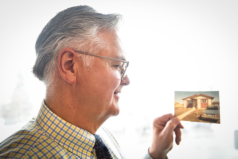 CREB® CEO Alan Tennant holds a photo of his first home, a Falconridge bungalow purchased in 1981.
Terence Leung / CREB®Now
