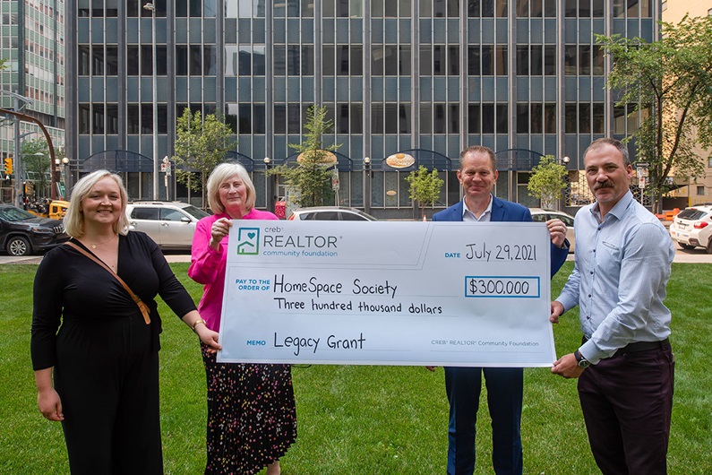 HomeSpace Society’s Emily Campbell (from left) and Wendy Cundall with CREB® REALTOR® Community Foundation chair Murray Scotton and CREB® communications director Jason Yule. (Cody Stuart / CREB®Now)